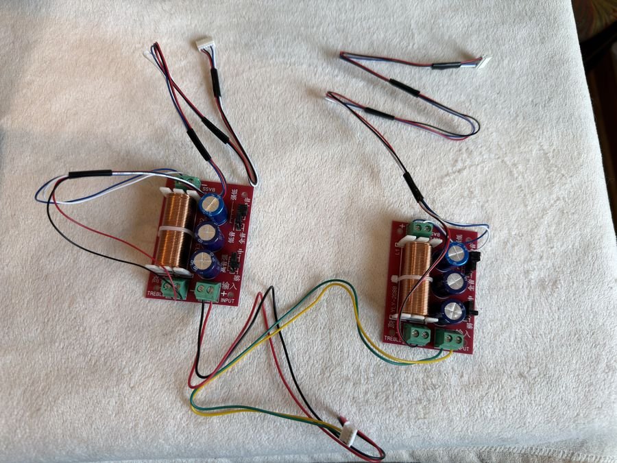 Two YLY-2088 speaker crossover boards with their inductors, capacitors and input, bass and treble terminals, wired with test leads